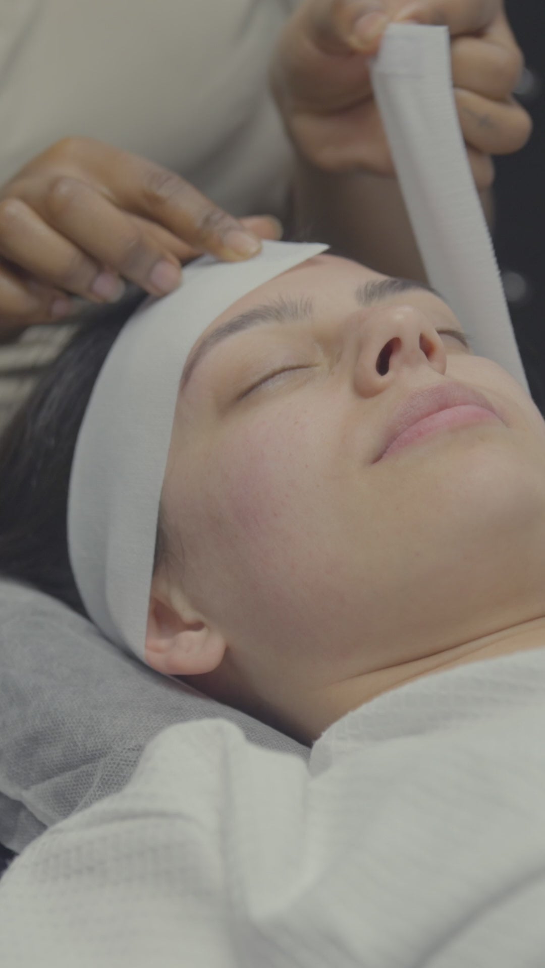 Load video: Video of a lady getting a Seasonal Glo&#39; Facial, with slow motion shots of a the Seasonal Glo&#39; Therapist Charnel smiling and applying premium products and using the steamer to relax and cleanse the clients face.